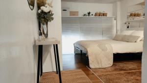 um quarto com uma cama e uma pequena mesa com uma cama sidx sidx em Estudio DuplexBCN em Barcelona