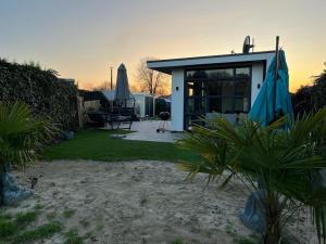 a small house with a patio and a yard at Luxus Chalet „WASSERBLICK“ in Lathum