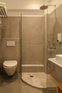 a bathroom with a shower and a toilet and a sink at Paros Bay in Parasporos