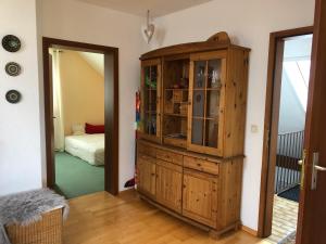 a room with a wooden cabinet and a bedroom at AUSZEIT für DICH in Himmelkron