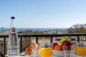 a table with a plate of fruit and a bottle of orange juice at Lacus Ocean in Lagos