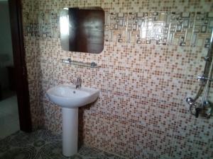 a bathroom with a sink and a mirror at Lovely 1-Bed duplex house in Abidjan