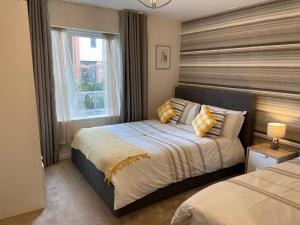 a bedroom with two beds and a window at Fortified Luxury Apartment in Chatham