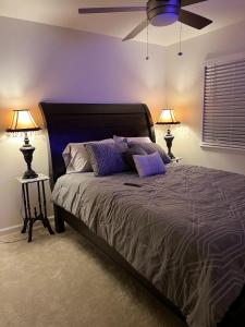 a bedroom with a large bed with two lamps at Well Appointed 3-Bedroom Townhome in Colorado Springs