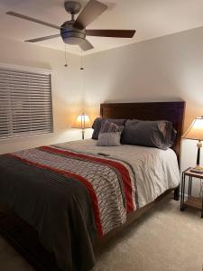 a bedroom with a bed with a ceiling fan at Well Appointed 3-Bedroom Townhome in Colorado Springs