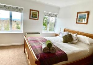 a bedroom with a bed with two towels on it at Haytor Court, Haytor, Dartmoor in Haytor