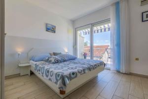 a bedroom with a bed and a large window at Studio Apartment in Crikvenica II in Dramalj