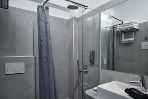 a bathroom with a shower and a sink at Paros Bay in Parasporos