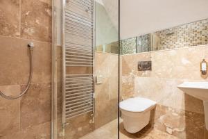 a bathroom with a shower and a toilet and a sink at Trewhiddle Retreat V27 by Together Travel - Luxury 3-Bedroom Villa in St Austell +26 photos