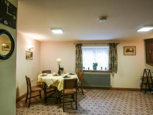 a dining room with a table and chairs and a window at Maltkiln Court in Bickley