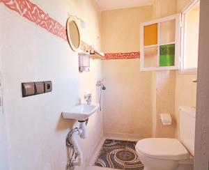 a small bathroom with a sink and a toilet at Araf House in Marrakesh