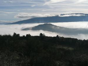a view of a mountain with a layer of clouds at Casa das Feitorias Douro Valley in Baião