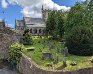 an old church with graves in front of it at The White Hart Inn, Hawes in Hawes
