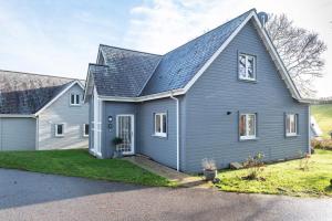 a gray house with a gray roof at Trewhiddle Retreat V24 by Together Travel - Luxury 4-Bedroom Villa in St Austell