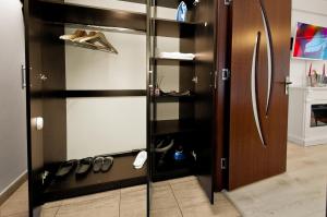 a closet with a glass door with shoes in it at Darin Aparthotel in Galaţi