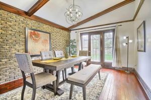 a dining room with a table and chairs and a brick wall at 5 Bedroom Vacation Cottage - King City in Schomberg