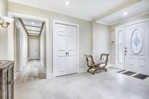 an empty hallway with a chair in a house at 5 Bedroom Vacation Cottage - King City in Schomberg