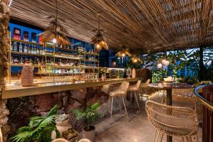 a bar in a restaurant with tables and chairs at Elcielo Hotel & Restaurant in Medellín