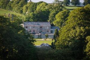 a large house in the middle of a forest at Trewhiddle Villa 18 in St Austell