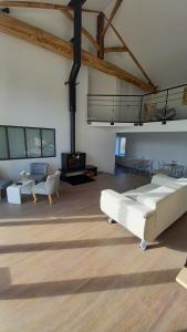 a large living room with a bed and a fireplace at La Maison du Lac in Flavignac