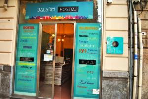 a door to a restaurant with signs on it at Balarm Hostel - Youth Hostel age limit 18-50 in Palermo