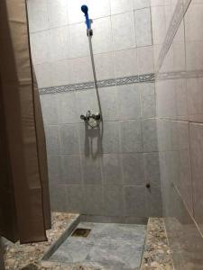 a shower with a hose in a bathroom at Chez Stef Taghazout in Taghazout +11 photos