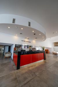 a lobby with a red counter in a building at Hotel Riviera in Mar del Plata