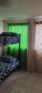 a room with two bunk beds and a green wall at El Quisco in San Antonio +13 photos