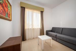 a living room with a couch and a table at Hotel Santa Catarina Algarve in Portimão