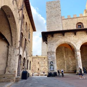 a group of people walking in an old building at L'Attico dei Sogni in San Gimignano