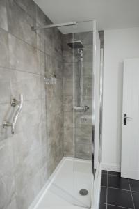 a shower with a glass door in a bathroom at The Fox Inn in Stourbridge