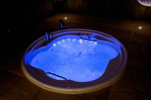 a blue bath tub in a dark room at Masseria Filippo de Raho - Agri Bio Relais in Villa Convento