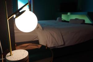 a bedroom with a bed and a table with a lamp at Grand hotel irpinia & Family SPA in Avellino