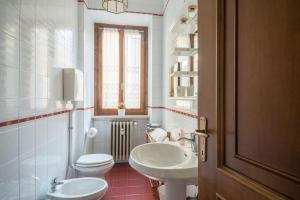 ein weißes Badezimmer mit 2 WCs und einem Waschbecken in der Unterkunft Interno66 in Brescia