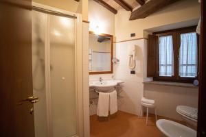 a bathroom with a sink and a toilet at Relais La Corte di Bettona in Bettona
