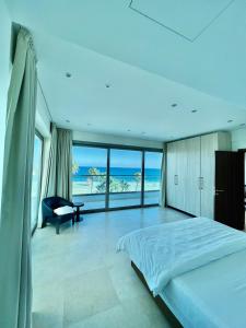 a bedroom with a bed and a view of the ocean at Aphrodite Plaza in Larnaka