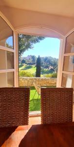 a room with a large window with a view of a yard at SUPERBE VILLA-DOMAINE AVEC GOLF PISCINE ET TENNIS in Saint-Cyr-sur-Mer