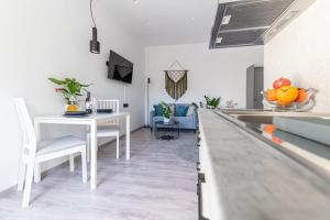 a kitchen and dining room with a white counter top at Elegant Fully Equipped Apartment near City Centre in Heraklio