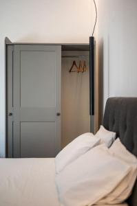 a mirror in a room with a bed and a closet at Elegant Fully Equipped Apartment near City Centre in Heraklio