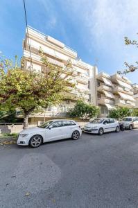 three white cars parked in front of a building at Elegant Fully Equipped Apartment near City Centre in Heraklio