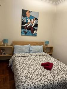 a bedroom with a bed and a painting on the wall at Vigo Excursions in Vigo