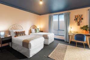a hotel room with two beds and a window at Roamer St Kilda - formerly Selina St Kilda Melbourne in Melbourne