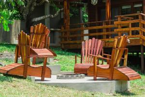 a group of chairs sitting in the grass at Anna Beach Village in Ponta do Ouro