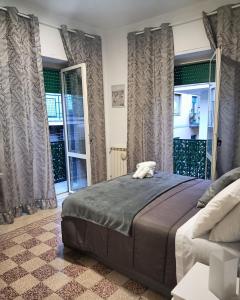 a bedroom with a bed and a couch and windows at Il Dubbio ai Quartieri Spagnoli in Naples