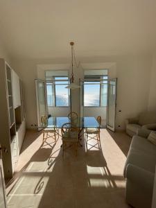 a living room with a table and chairs and a couch at CasAmare di Carla in Savona