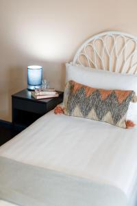 a bed with a pillow and a side table at Roamer St Kilda - formerly Selina St Kilda Melbourne in Melbourne