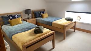 a bedroom with two beds and a window at Telford Escape in Elgin