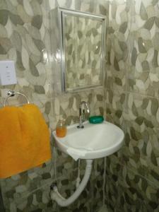 a bathroom with a sink and a mirror at Espaço interno in Salvador
