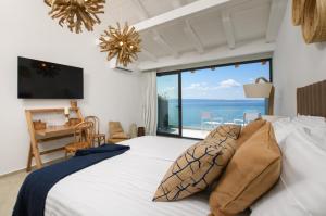 a bedroom with a bed with a view of the ocean at Gallery Luxury Suites & Rooms-Only Adults in Split