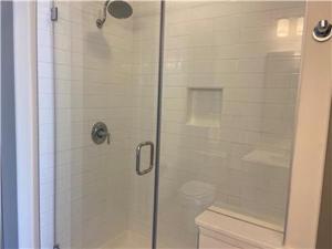 a bathroom with a glass shower with a toilet at Resort Style Apartments in Spring, TX in Spring